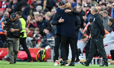 Klopp and Pep Guardiola embrace on the sidelines at Anfield