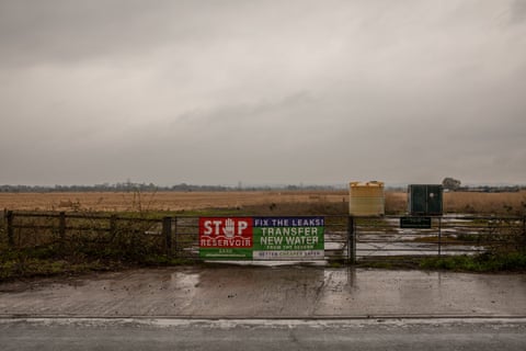 Sign on a fence next to a field says ‘Stop the Reservoir! Fix the Leaks’