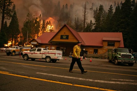 Firefighters work to protect the Strawberry Station general store on Highway 50 in Strawberry, California.