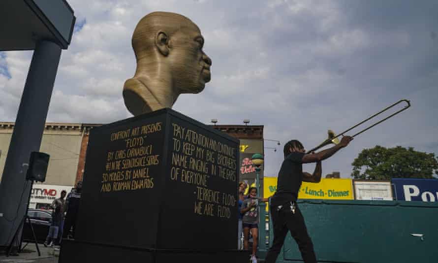 Jonte ‘Jonoel’ Lancaster plays trombone during a celebration for the refurbished George Floyd statue, after it was vandalized.
