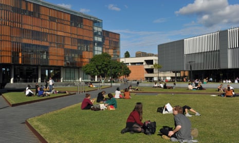 Students sit on the lawn at the University of Sydney.