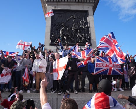 People with flags stood in Trafalgar Square
