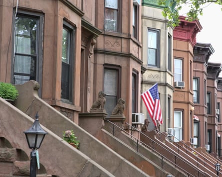 American flag hanging from the front door of a brownstone in a typical middle-class residential neighbourhood in Brooklyn, New York City.