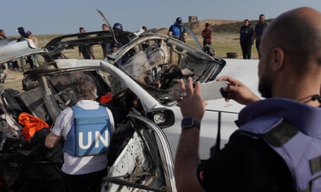 United Nations staff members inspect the carcass of a car used by US-based aid group World Central Kitchen, that was hit by an Israeli strike the previous day in Deir al-Balah in the central Gaza Strip, on April 2, 2024.