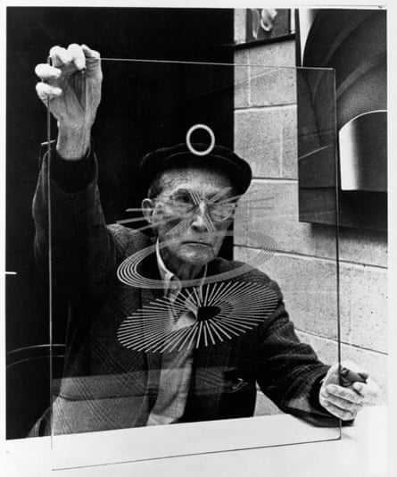 Marcel Duchamp holding a glass study for The Large Glass: The Bride Stripped Bare by Her Bachelors, Even.