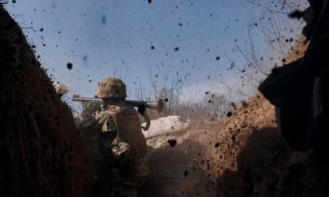 A Ukrainian soldier fires a grenade launcher on the frontline during a battle with Russian troops near Bakhmut.