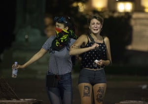 Thousands of people demonstrated in several Serbian cities on Friday. These two women were photographed in Belgrade.