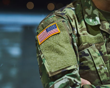 Cropped shot of a soldier wearing camouflage fatigues with an American flag for a patch.
