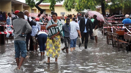 Voters outside a flooded polling station in Kinshasa.