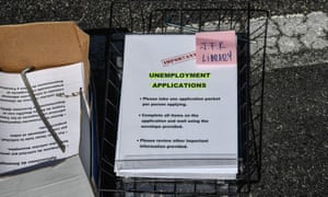 Paper unemployment forms are distributed at a drive-thru collection point in Hialeah, Florida, on 8 April.