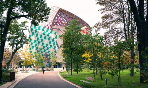 Museum of modern art Foundation Louis Vuitton, view from the Park with walking people, early autumn