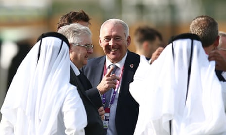 Mark Drakeford, centre left, talks with Qatari officials during a Wales training session in Doha on Sunday.