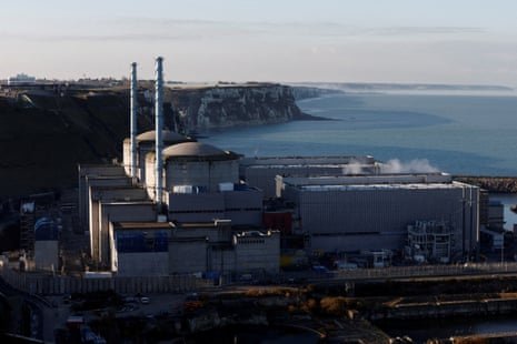 A view of a French nuclear power plant with the ocean and cliffs behind it