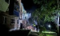 Firefighters work on Friday night at a residential building hit by a Russian missile strike in Kharkiv, amid Russia's attack on Ukraine.