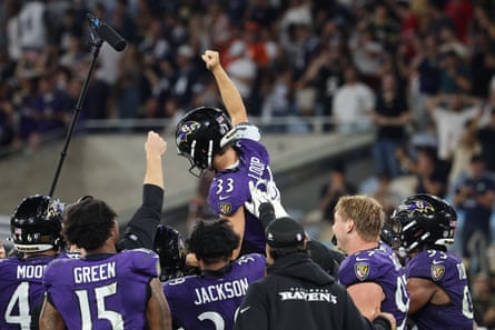 Tyler Loop and the Baltimore Ravens celebrate after defeating the Dallas Cowboys at the Maracanã in Rio