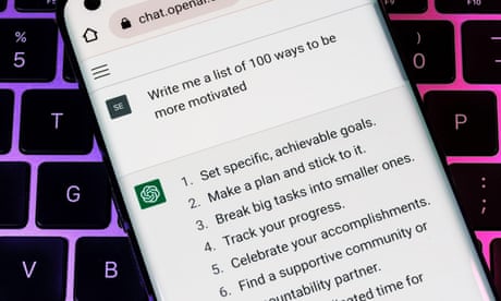 ChatGPT chatbot seen on smartphone placed on laptop.