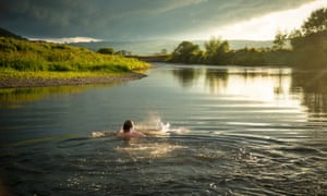 Daniel Start wild swimming in a River.