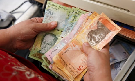 Cashier counts Venezuelan bolivar notes