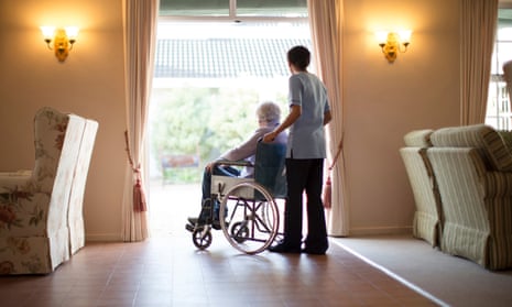 Nurse pushing aged care resident in wheelchair