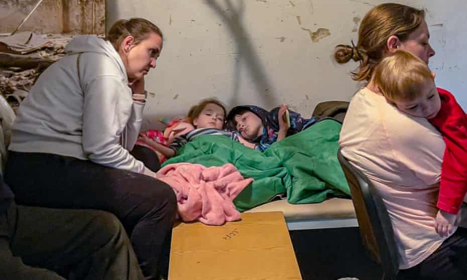 Local citizens of Chernihiv hide in the basement of Chernihiv Central Hospital after an airstrike alert.