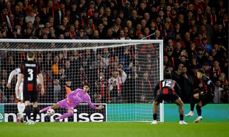 Marcus Tavernier scores a penalty past the diving goalkeeper in a packed stadium