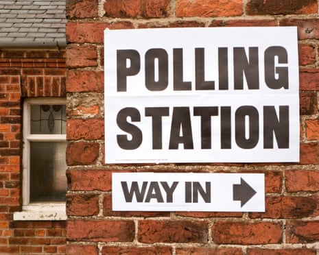 Polling station signs on brick wall during UK general election