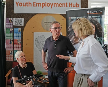 Alan Milburn by a ‘youth employment hub’ sign talking to people