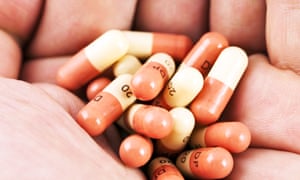 Antibiotic capsules in a hand