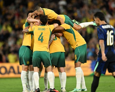 Connor Metcalfe of the Socceroos is mobbed by teammates after his goal.