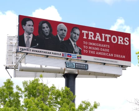 red billboard with black and white photos of three men and one woman reads âÂÂTraitors, to immigrants, to Miami-Dade, to the American dreamâ with a line on the bottom saying âÂÂprotect humanitarian paroleâÂÂ