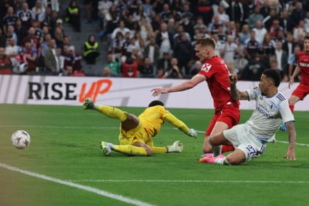 Morgan Rogers of Aston Villa slides in to score the third goal against Freiburg