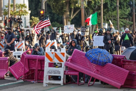 Activists hide behind a makeshift barricade during protests sparked by immigration raids in Los Angeles, California, USA, 08 June 2025.