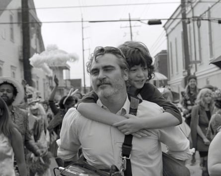 Man with boy on his shoulders in a crowd