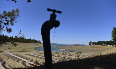 Water drips from a faucet near boat docks sitting on dry land at the Browns Ravine Cove area of drought-stricken Folsom Lake, California
