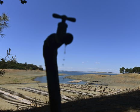 Water drips from a faucet near boat docks sitting on dry land at the Browns Ravine Cove area of drought-stricken Folsom Lake, California