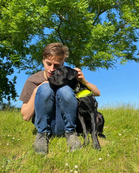 Gunnarsson and Max sitting on a grass bank with trees behind them