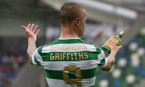 Celtic’s Leigh Griffiths holds a glass bottle that appeared to have been thrown at him from the stands at Windsor Park.