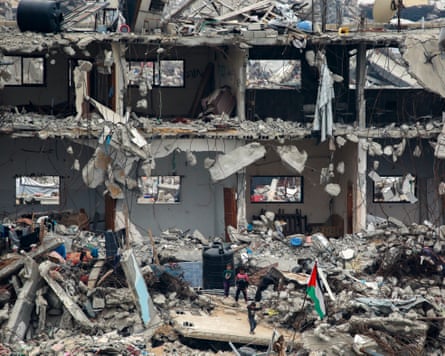 Rubble, a Palestinian flag and children