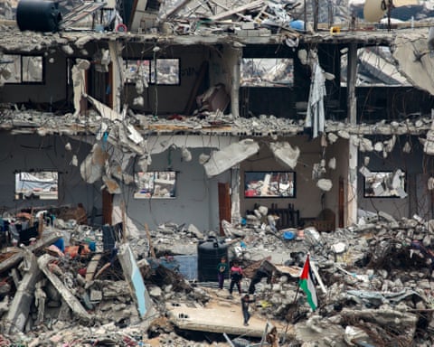 Rubble, a Palestinian flag and children