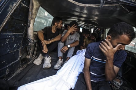 The body of a Palestinian who died when Israeli troops opened fire at the Zikim crossing is transported to al-Shifa hospital on Sunday 3 August.