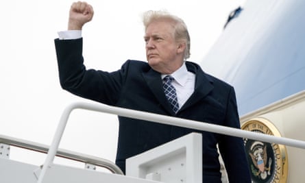 Donald Trump gestures as he boards Air Force One.