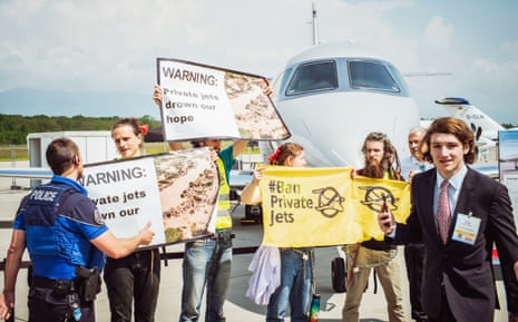 Activists supporting Greenpeace, Stay Grounded, Extinction Rebellion, Scientist Rebellion and other climate movement groups hold banners during a demonstration against Private jets at the European Business Aviation Convention & Exhibition (EBACE) in Geneva today.