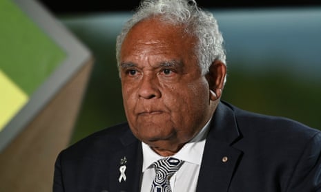 Professor Tom Calma AO receives the 2023 Senior Australian of the Year award during the 2023 Australian of the Year Awards. He is an Indigenous Australian man with short white hair and is wearing a dark suit, white shirt and black-and-white graphic patterned tie
