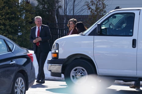 people walk near a car