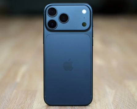 The back of the iPhone 18 Pro Max in black stood up on a wooden table