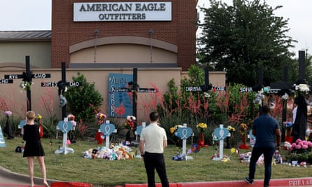 People visit the memorial set up near the scene of a mass shooting at the Allen Premium Outlets mall in Allen, Texas, after eight people were killed on 6 May.