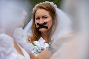 Boston, US Advocates and child marriage survivors from the group Unchained at Last put on wedding gowns, veils, chains and tape over their mouths as they gather on Boston Common before marching to the State House to call for an end to child marriages, in Massachusetts
