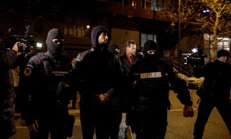 Andrew Tate and his brother Tristan are escorted by police officers in Bucharest,Romania, on 29 December.
