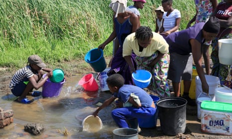Women and children fetch water in the township of Luveve in Bulawayo.