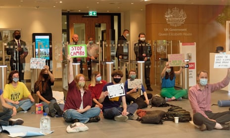 Climate activists blocking the entrance to a new UK government hub in Edinburgh in July to protest against the Cambo oilfield’s approval. 